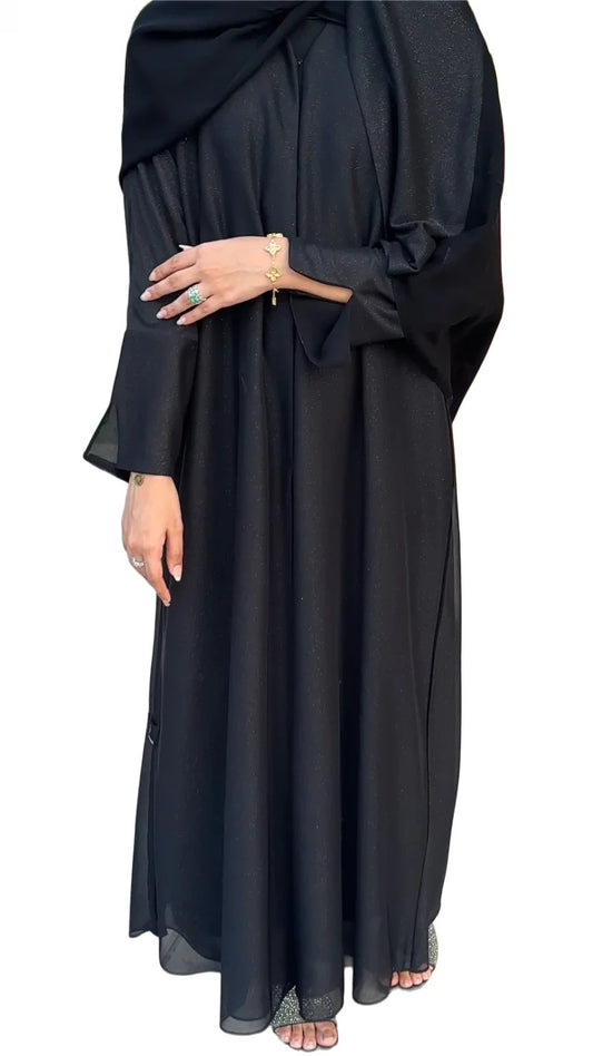 Black abaya worn by a women on a white background