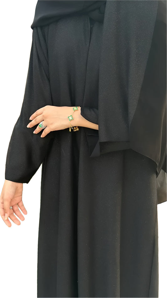 Black abaya worn by a women on a white background