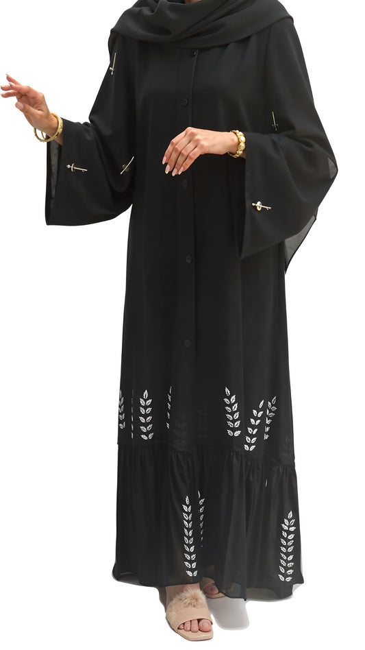 Black abaya with white leaf patterns on a white background