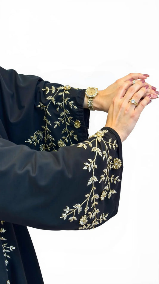 Navy blue garment with gold embroidery on a white background