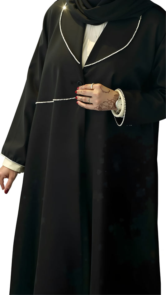 Black abaya with white trim on a white background