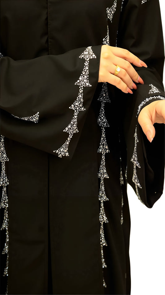 Black abaya with silver embroidery on a white background
