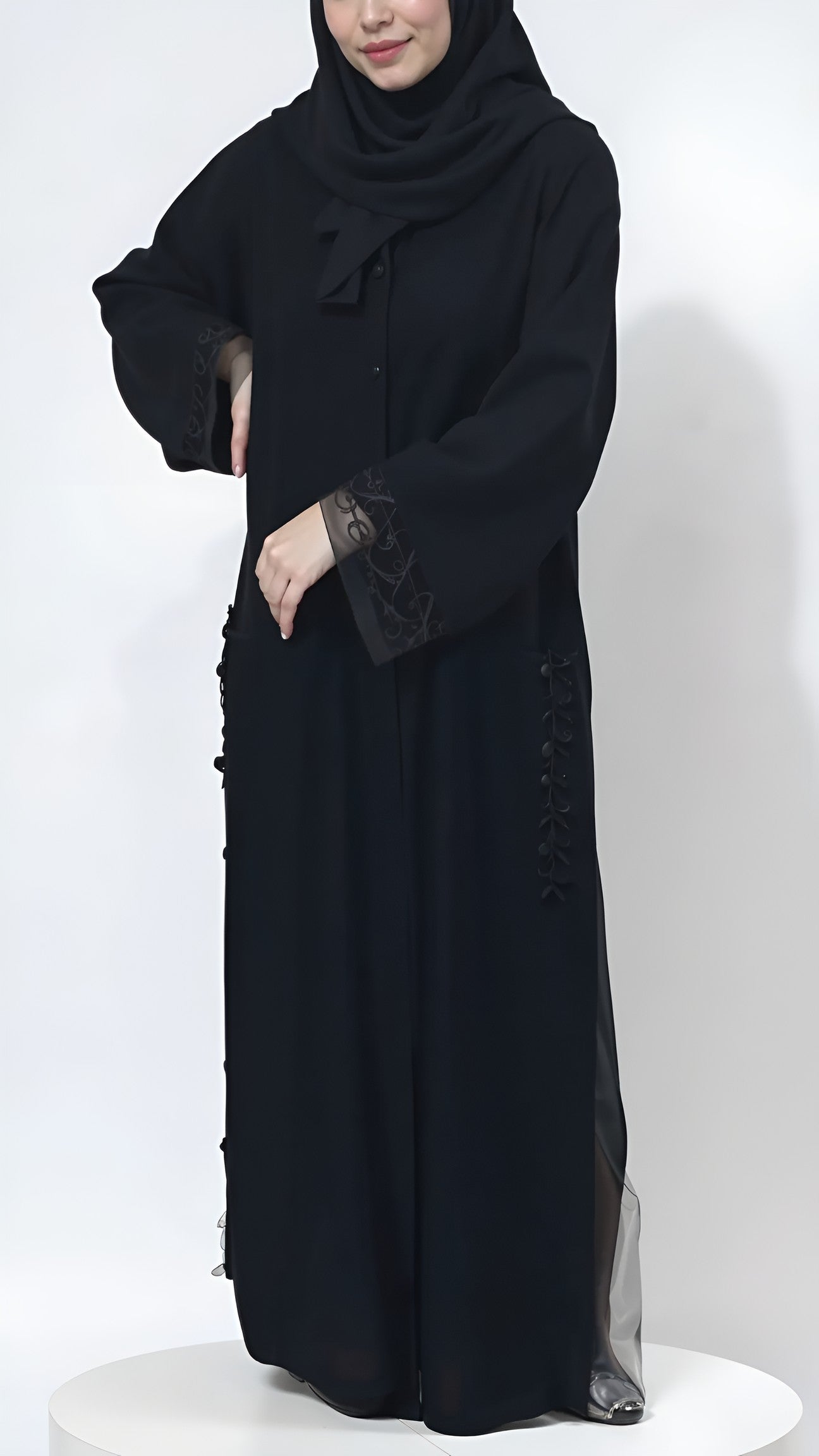 Person wearing a black abaya on a white background