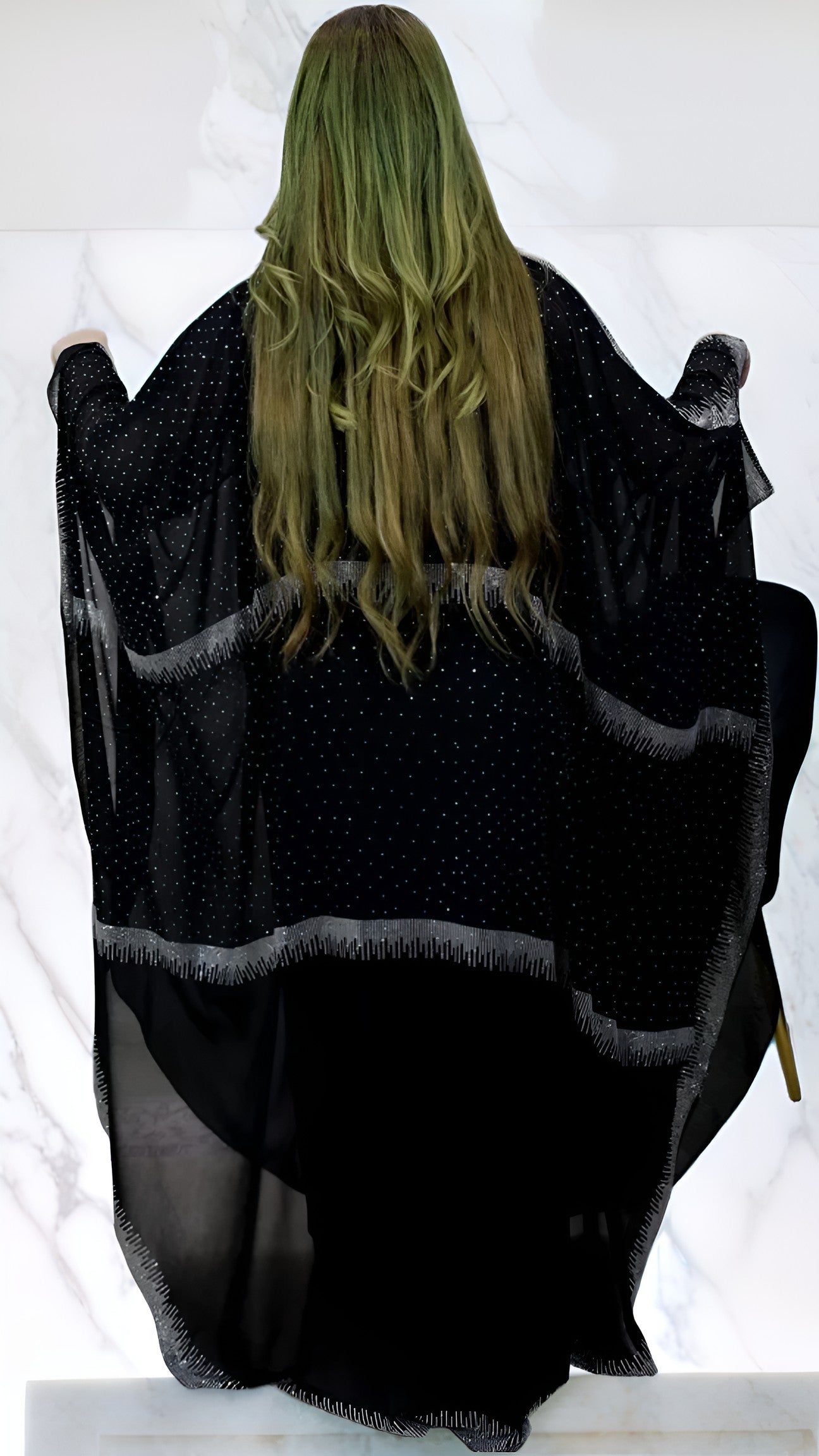 Women wearing a black poncho with a white background