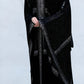 Women wearing a black patterned abaya on a white background